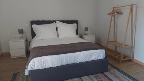 a bedroom with a large bed with white pillows at Casa da Fraga in Soajo