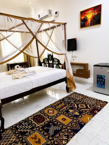 a bedroom with a bed and a rug at Lamu Creek Hotel in Lamu