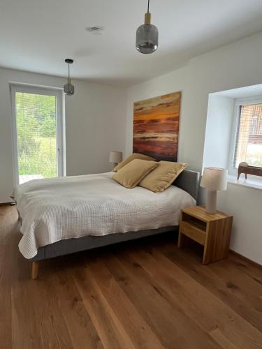 a bedroom with a bed and a table and a window at Refugium Mitterbach in Mitterbach