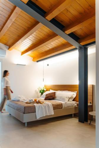 a bedroom with a large bed with a wooden ceiling at Antiche Cantine Bed & Breakfast in Alcamo