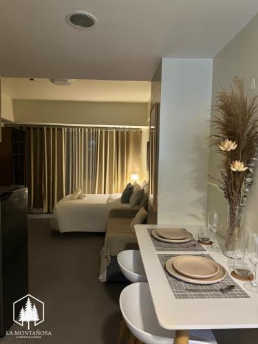 a living room with a couch and a bed at La Montañosa at Brenthill Baguio Condo near City Center in Baguio
