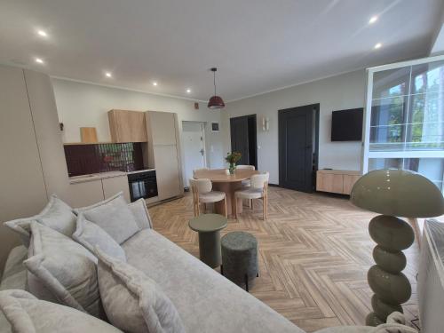 a living room with a couch and a table at Apartamenty u Justyny - Ametyst in Borne Sulinowo