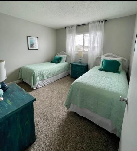 a bedroom with two beds and a window at Sandy Toes Getaway in Hilton Head Island