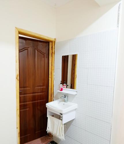 a bathroom with a sink and a mirror at Mura suites homes in Nakuru