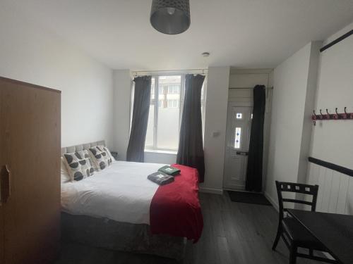 a bedroom with a large bed and a window at Modern Studio with Free Parking near sea-station-shops in Portslade