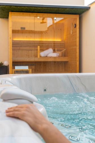 a person in a jacuzzi tub in a room at Antiche Cantine Bed & Breakfast in Alcamo