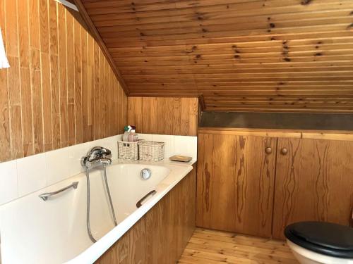a bathroom with a tub and a toilet at Phare - SAINT HILAIRE DE RIEZ in Saint-Hilaire-de-Riez