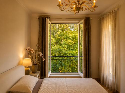 a room with a bed and a window with a view at SeWeR Apartment in Baden-Baden