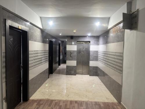 a hallway with elevators in a building at Grand Almada Inn in Lucknow