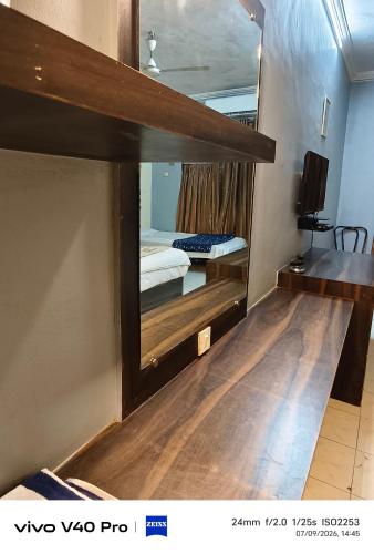 a room with two bunk beds and a mirror at Hotel HLD Matheran in Matheran