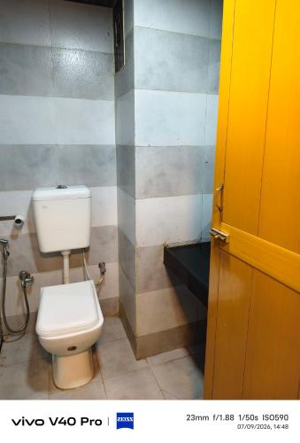 a bathroom with a white toilet in a room at Hotel HLD Matheran in Matheran