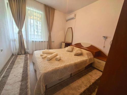 a bedroom with a bed with towels on it at Hristean Apartment Petrich in Petrich