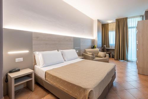 a bedroom with a bed and a living room at Hotel Miramonti in Turin