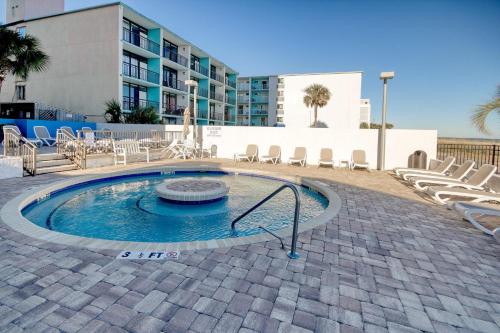 a small swimming pool with chairs and aurned at Ocean Park Resort in Myrtle Beach