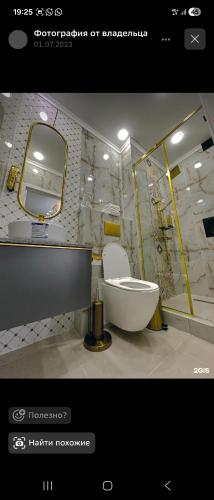 a bathroom with a tub and a sink and a mirror at Qas-saQ in Türkistan