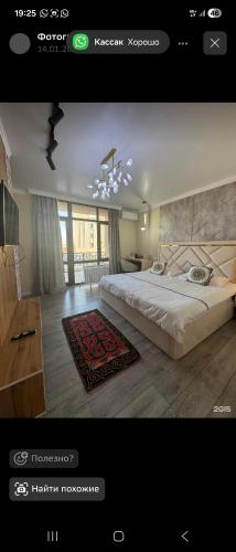 a bedroom with a large bed and a chandelier at Qas-saQ in Türkistan