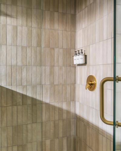 a bathroom with a shower with a glass door at Camp DeForest in Lincolnville