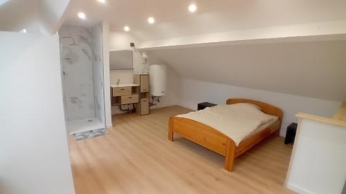 a bedroom with a bed and a desk in it at L'entracte in Hensies