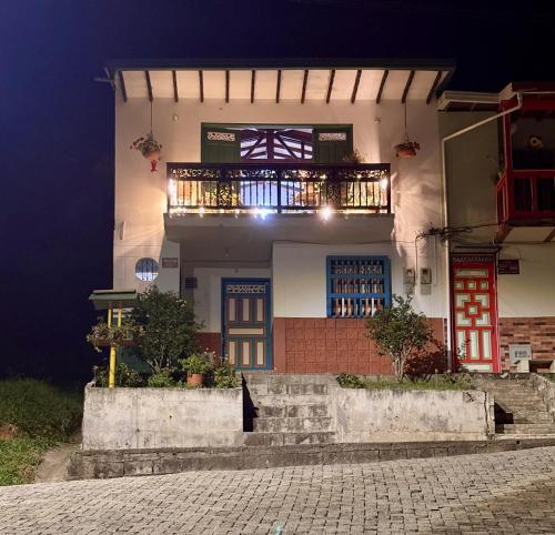 a building with a balcony on the side of it at Blomst Casa Hostal in Jericó