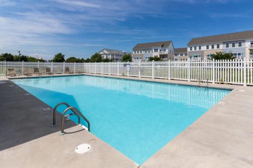 a large swimming pool with a white fence at Seaside Village --- #3 in Ocean City