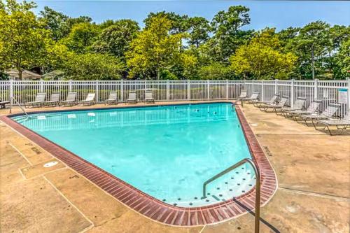 a swimming pool with chairs and a fence at Whispering Woods #26 in Ocean City