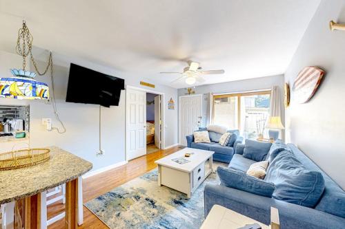a living room with a blue couch and a table at Whispering Woods #26 in Ocean City