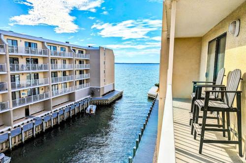 a balcony of a hotel with chairs on the water at Wight Bay North #439 in Ocean City