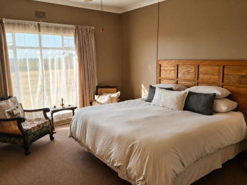 a bedroom with a large bed and a window at Nawi Unit 3 in Potchefstroom