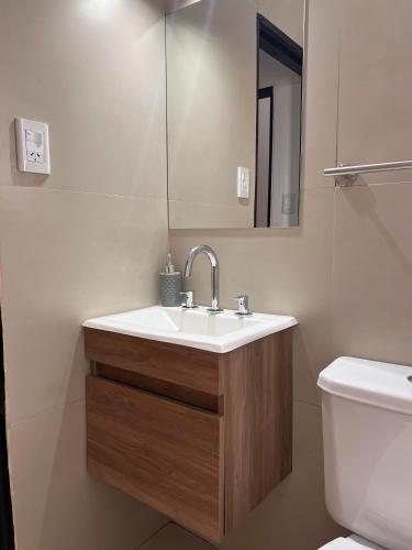 a bathroom with a sink and a toilet at Olivos Lujan in Luján
