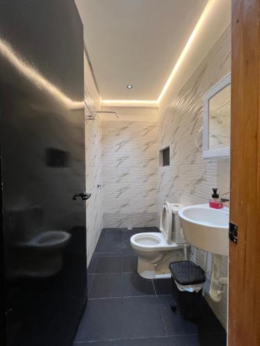 a bathroom with a white toilet and a sink at Hotel Magic Capurganá in Capurganá