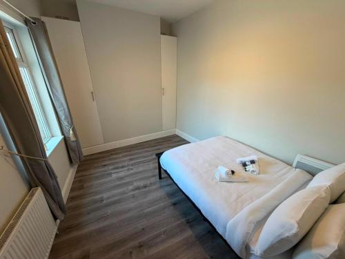 a room with a bed with two stuffed animals on it at Stylish Bolton Stay Parking Walk to Town Centre in Farnworth