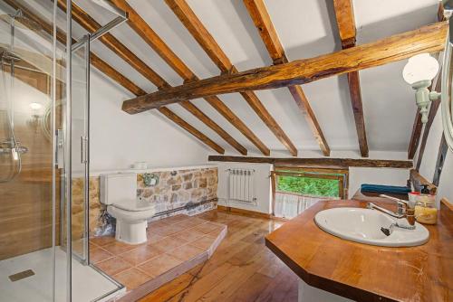 a bathroom with a toilet and a glass shower at Casa Del Tesoro in Triongo