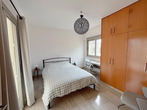 a bedroom with a bed with a checkered blanket at Leda Beach Villa in Polis Chrysochous