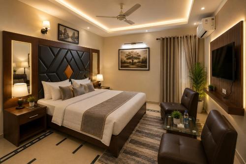 a hotel room with a large bed and a chair at Subhan Palace Guest House in Karachi