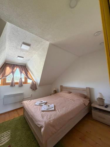 a bedroom with a bed and a window at Villa Lux in Žabljak