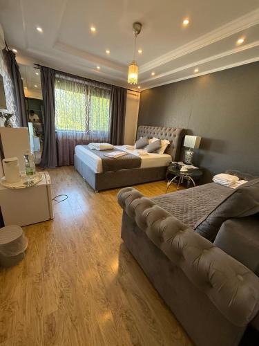 a living room with two beds and a couch at Ami Residence Bucharest Airport,Therme&FREE PARKING Otopeni in Otopeni