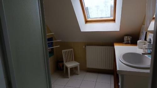 a small bathroom with a sink and a window at Sterne pierregarin 2kms de la plage in Séné