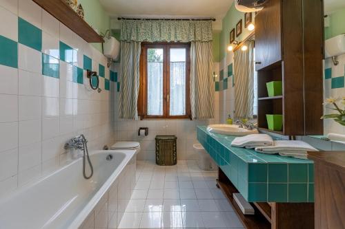 a bathroom with a tub and a sink at CASALE LE CONCE 6, Emma Villas in Castel del Piano