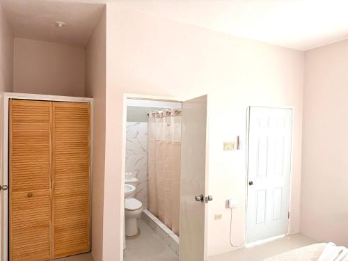 a bathroom with a toilet and a shower at Olive Breeze III in Runaway Bay