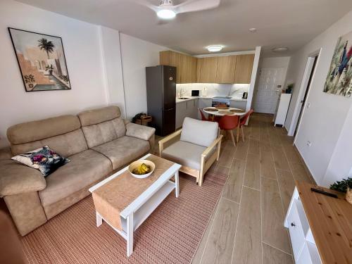 a living room with a couch and a table at Pool View Apartment Garden City in Costa de Adeje