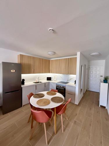 a kitchen with a table and chairs in a room at Pool View Apartment Garden City in Costa de Adeje