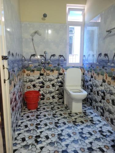 a bathroom with a shower and a toilet in it at Vatiguesthouse in Shillong