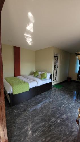 a bedroom with two beds in a room with water on the floor at Vatiguesthouse in Shillong