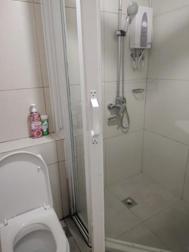 a bathroom with a shower and a toilet at Tala Transient House in Baguio