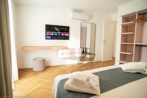 a bedroom with a bed and a tv on the wall at Appartamento Costanza in Letojanni