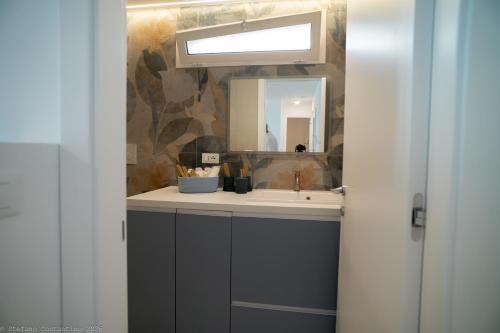 a bathroom with a sink and a mirror at Appartamento Costanza in Letojanni