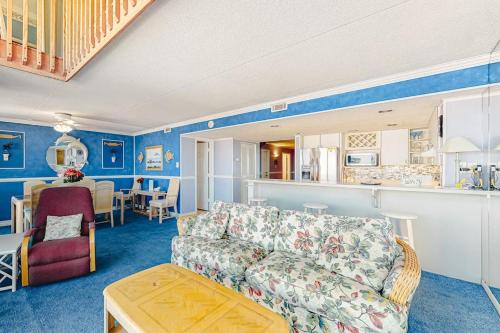 a living room with a couch and a kitchen at Sea Watch 1910 in Ocean City