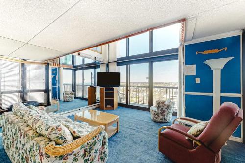 a living room with a couch and chairs and a tv at Sea Watch 1910 in Ocean City