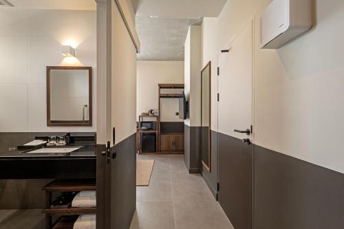 a kitchen with a sink and a counter top at Prano Hotel in Bangkok