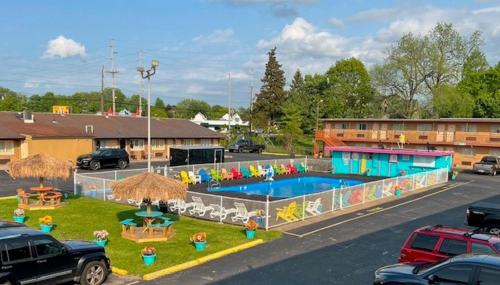 a large pool in a parking lot next to a building at Wolf Inn Hotel in Sandusky